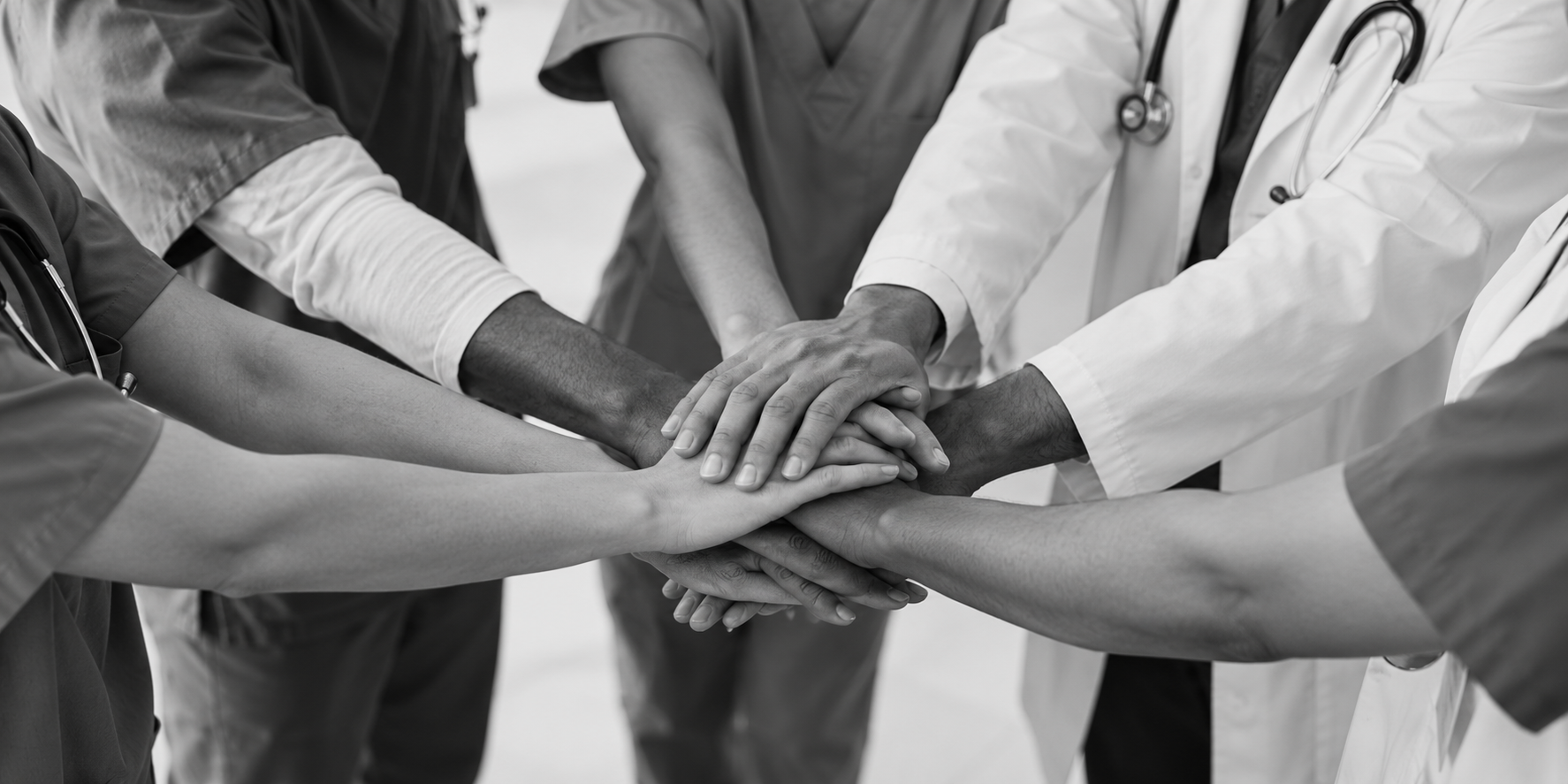 Healthcare professionals joining hands together